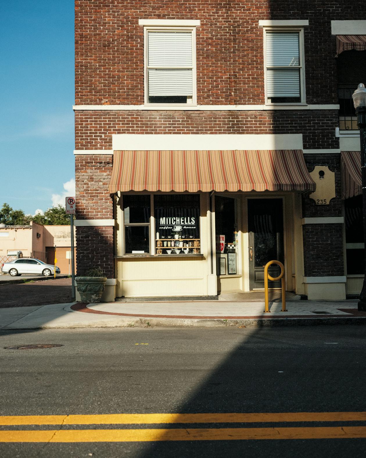 Quaint brick small town storefront the kind of setting a cozy mystery opening builds